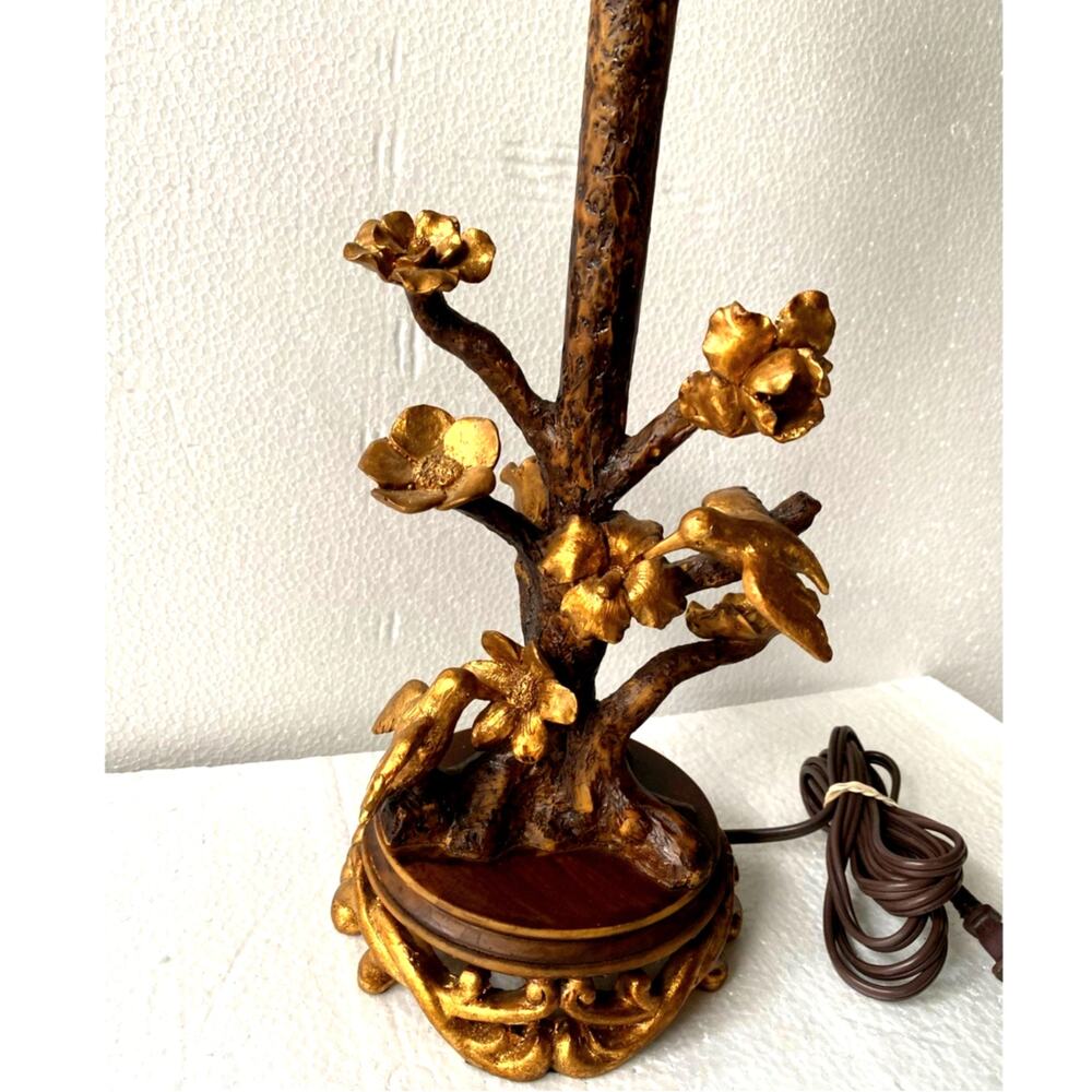 Antique floral and bird table lamp featuring a rustic tree-branch stem